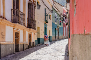 narrow colonial street with a person in Bolivia