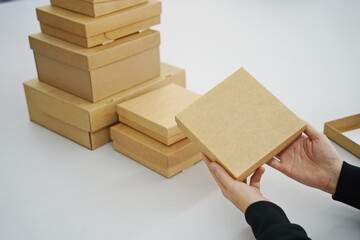 A woman holds cardboard boxes for parcels and delivery