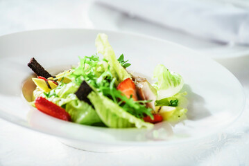 chicken salad with strawberry on the white plate