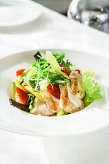 chicken salad with strawberry on the white plate