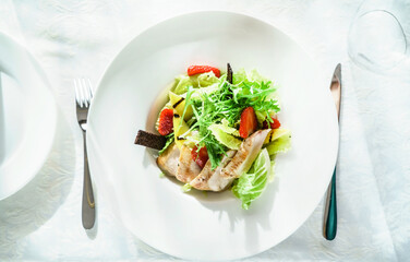 chicken salad with strawberry on the white plate