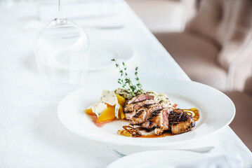 roasted duck with sauce and herbs