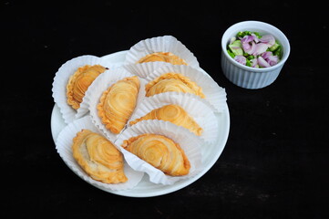 Chichen Curry Puffs on white plate