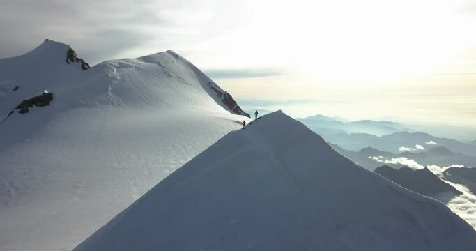 Epic Aerial view above top summit of snowy mountains Monte Rosa Ludwigshohe Pyramide Vincent during Sunrise, orbit flying around, Alps Italy DJI Mavic Pro