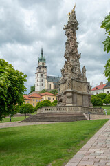 Holy Trinity plague column with castle in the background. Kremnica. Slovakia.