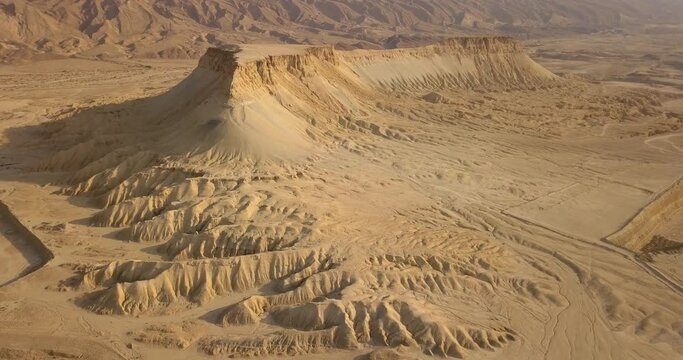 Special Mountain with flat top reveal in the desert in the wild with ridges looking like roots during a summer sunrise with sand clear skies sky, Aerial, Tsin Mountain, Negev Desert, Israel