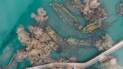 Boat cemetery located in the province of Treviso in Casier. Dead boats in crystal clear water with...