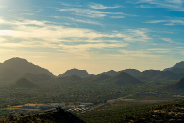 Rocky moutains in the hills of Arizona in the sonora desert at sunset with whispy clouds and...