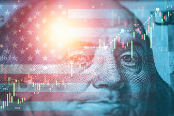 Closeup Benjamin Franklin face on USD banknote with USA flag and stock market chart graph for currency exchange and global trade forex concept.