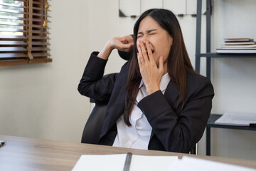 Bored businesswoman yawning at workplace feeling no motivation or lack of sleep tired of boring office routine, exhausted restless employee gaping suffering from chronic fatigue or overwork concept