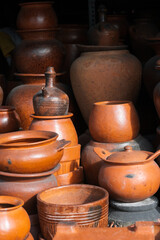 Fototapeta na wymiar Clay utensils. Pots, jugs, stand on the market for sale.