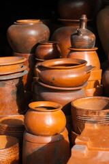 Fototapeta na wymiar Clay utensils. Pots, jugs, stand on the market for sale.
