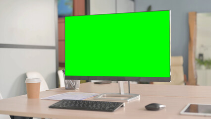 Desktop with Green Screen on Table in Office