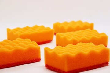 Set of orange sponges for washing dishes