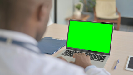 African Doctor Using Laptop with Green Screen