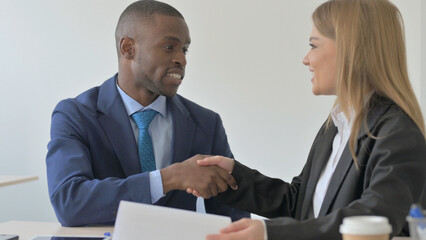 Mixed Race Young Business People Discussing Work, Paperwork