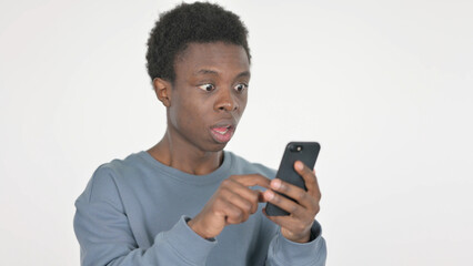 Young African Man Upset by Loss on Smartphone on White Background