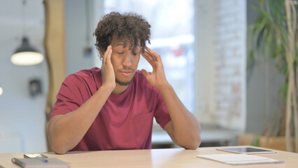 Fototapeta premium Tired African Man with Headache, Migraine at Work