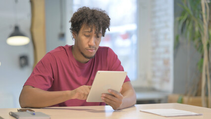 African Man using Digital Tablet, Browsing Internet