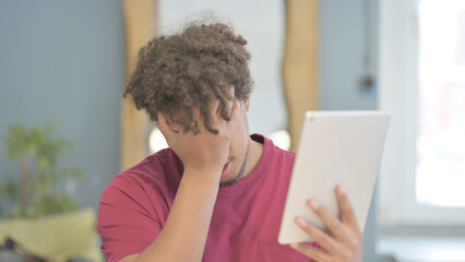 African Man Reacting to Loss on Digital Tablet