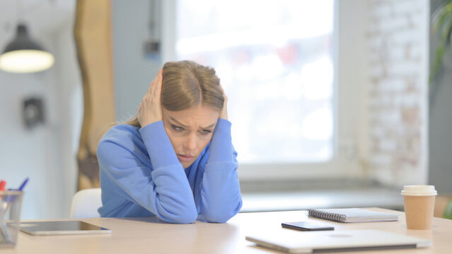 Embarrassed Woman Sitting In Depression And Anxiety At Work