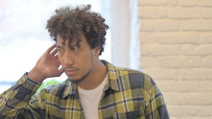 African Man Listening Secret Information in Office