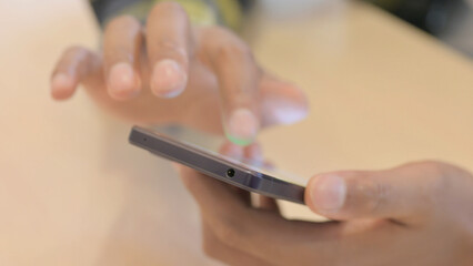 Close up of African Man Browsing Internet on Smartphone