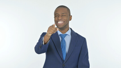 African Businessman Pointing at the Camera on White Background