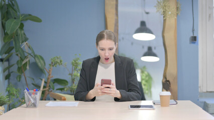 Upset Businesswoman Reacting to Loss on Smartphone