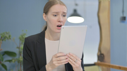 Shocked Businesswoman Reacting to Loss on Digital Tablet
