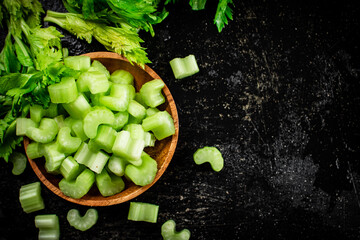 Pieces of fresh celery in a wooden plate. 
