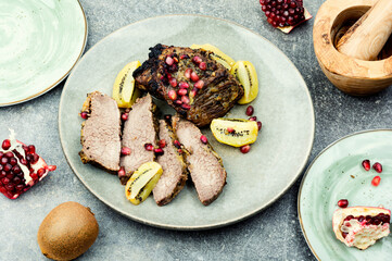Beef meat baked with kiwi and pomegranate.