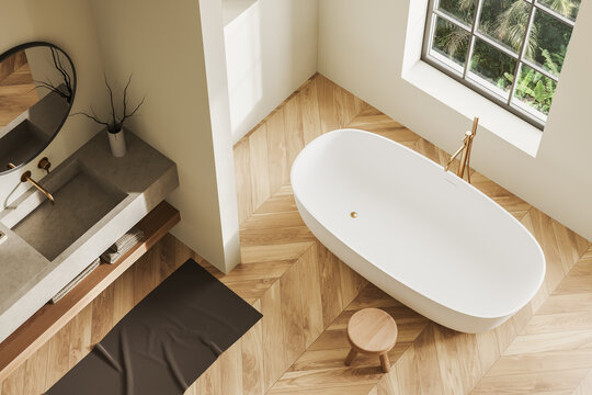 Top view of light bathroom interior with sink and tub with accessories