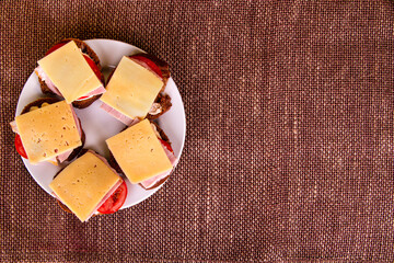 Open sandwiches with ham and cheese. Self-made food. Top view. Place for text.