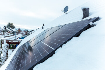 panel at rooftop with snow. removing snow off solar panels in winter. Removing snow photovoltaic...