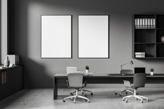 Dark office room interior with two empty white posters