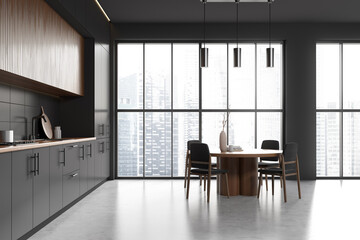 Modern kitchen interior with cooking and eating area near panoramic window