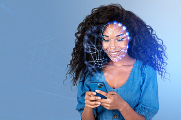 African woman with smartphone smiling, using facial scanner
