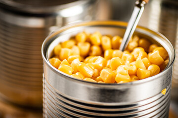 An open can of canned corn. 