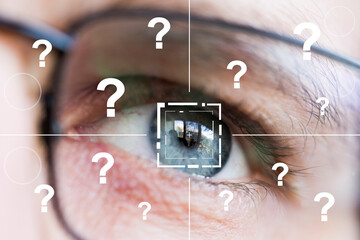 Eye monitoring and question icon on background of the male eye close up.