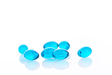 Blue jelly pills placed on white background
