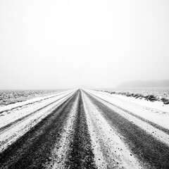 Naklejka premium Small gravel road at foggy winter day at Ypäjä, Finland.