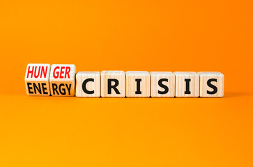 Energy or hunger crisis symbol. Concept word Energy crisis and hunger crisis on wooden cubes. Beautiful orange background. Business Energy or hunger crisis concept. Copy space.