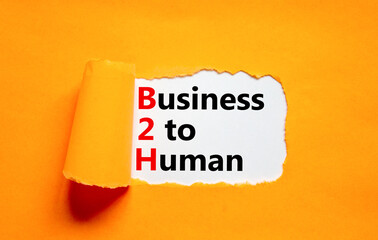 B2H business to human symbol. Concept words B2H business to human on white white paper on a beautiful orange background. Business and B2H business to human concept. Copy space.