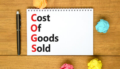 COGS cost of goods sold symbol. Concept words COGS cost of goods sold on white note on beautiful wooden background. Business COGS cost of goods sold concept. Copy space.