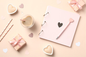 Happy Valentines Day composition. Flat lay, top view photo album, heart-shaped candles, coffee cup, Valentines gift boxes on pastel beige background