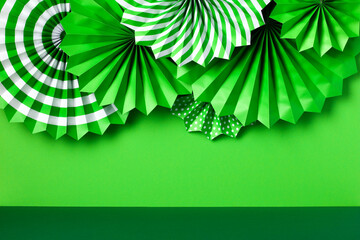Happy St Patrick's Day concept. Patricks Day paper fans ornaments on abstract green background
