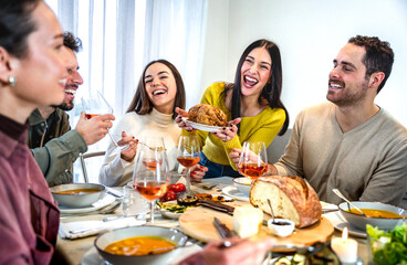 People having fun at dinner party - .Guys and girls enjoying time together while eating and drinking - Family and friendship concept