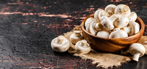 Mushrooms in a wooden plate on a napkin. 