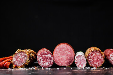 Various slices of salami sausage in a row. 